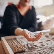 Person with sand tray