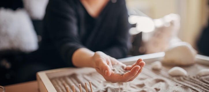 Person with sand tray